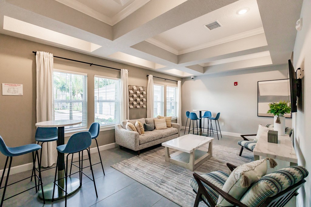 a living room with a couch and chairs and a table