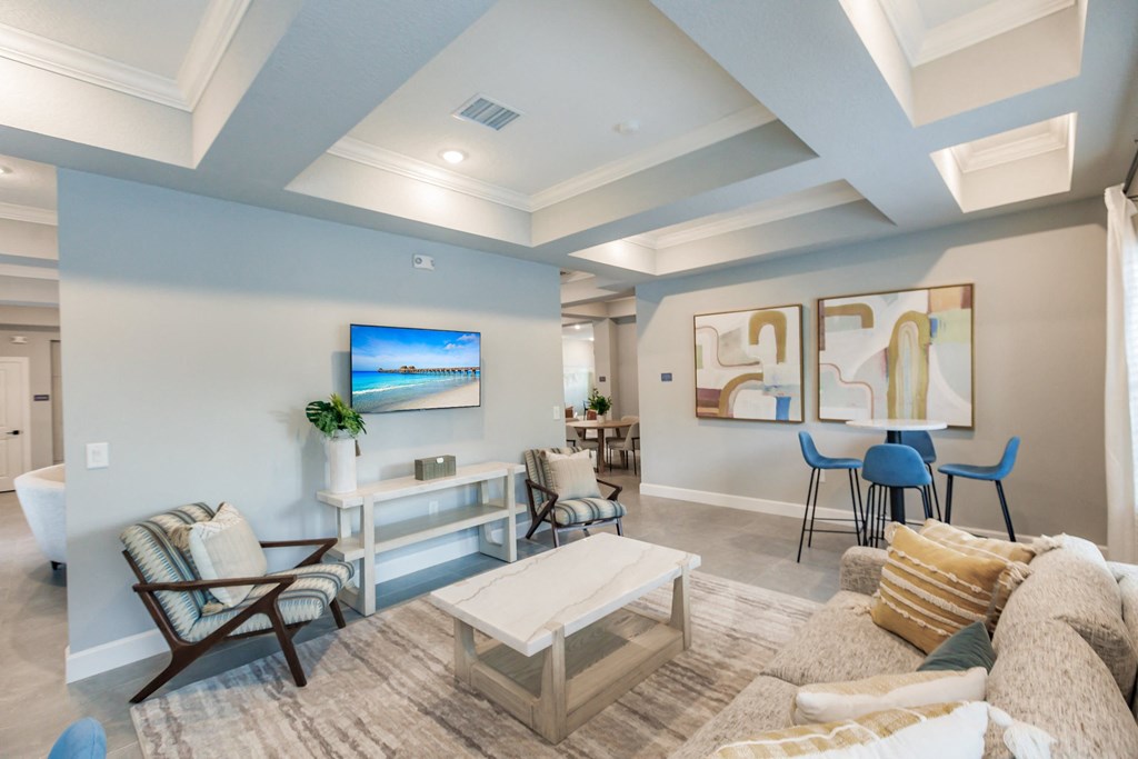 a living room with a tv, a couch and coffee table