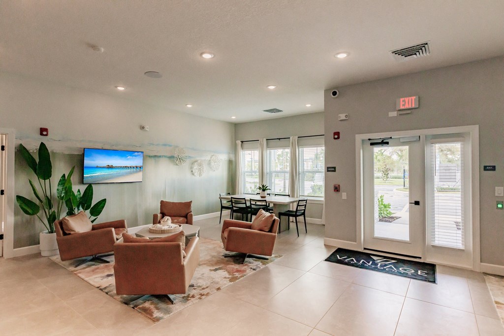 lounge area with chairs and a tv at Vantage Luxury Apartments in  Cape Coral, FL