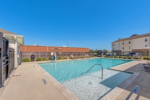 A swimming pool with a metal ladder in the middle of it.