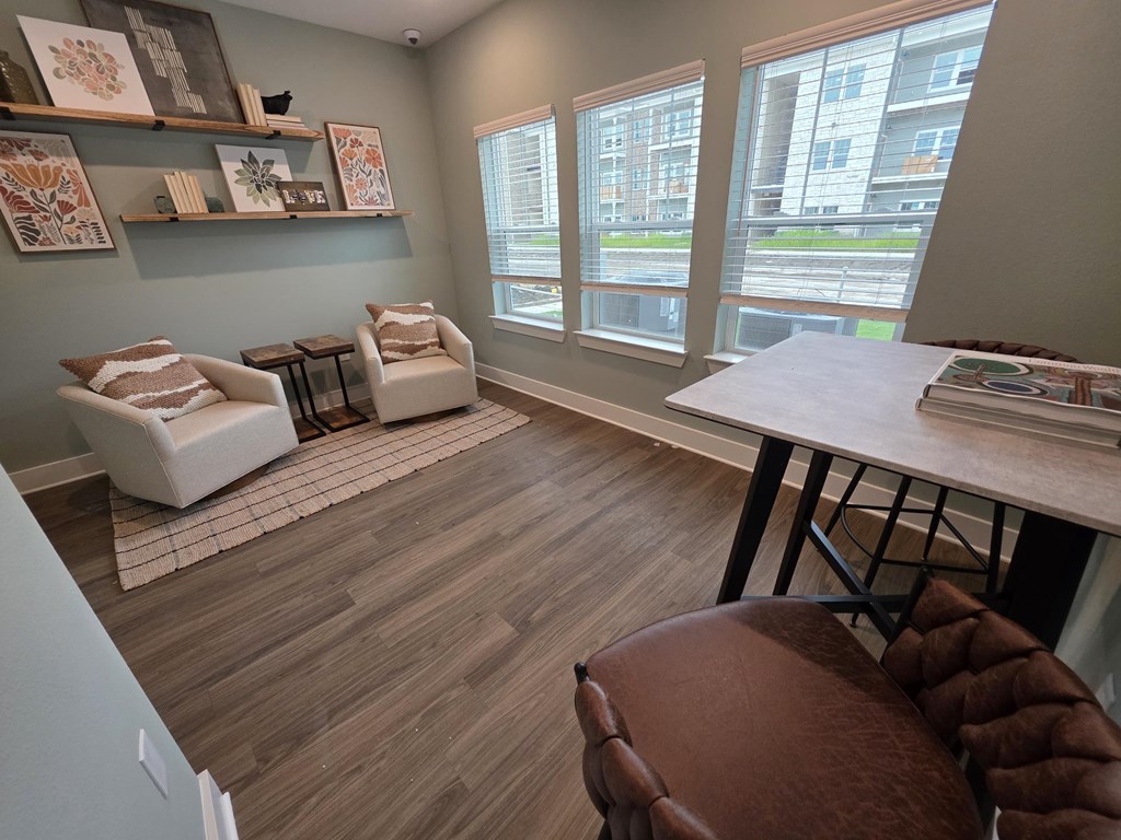 A room with a brown chair and a white couch.