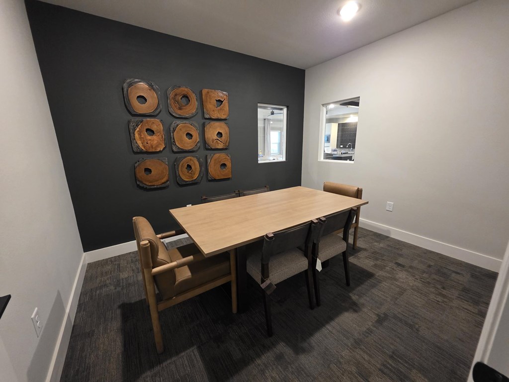 A conference room with a table and chairs.