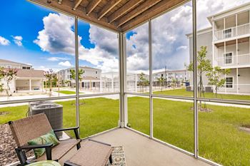 a patio with a screen enclosure at swiftwater luxury apartments in port charlotte fl