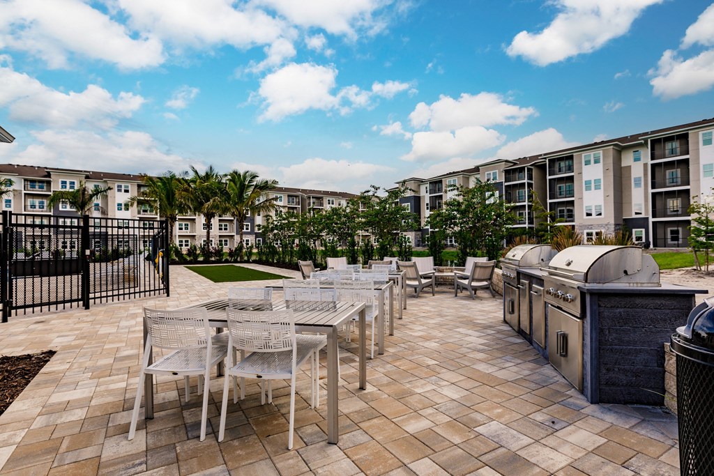 chairs, tables, and grills at Vantage apartments in cape coral, fl