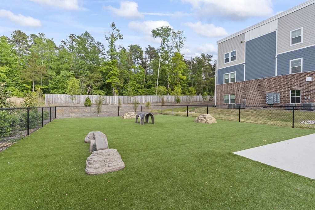 A playground with a slide and a rocking horse.