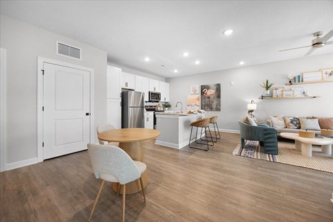 A modern kitchen with a dining table and chairs.