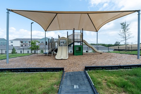 A playground with a slide and a green box.