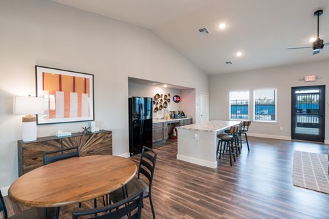 A modern dining room with a wooden table and chairs.