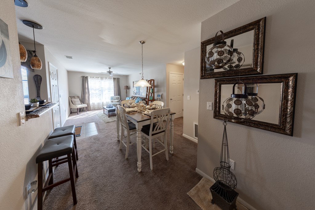 A dining room with a table set for six people.