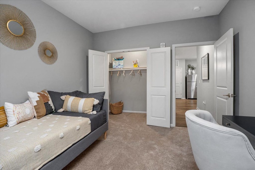 a bedroom with two beds and a closet