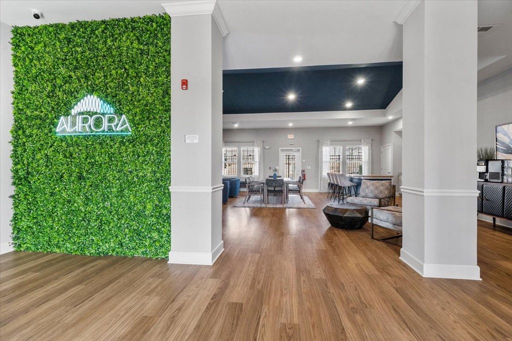 Aurora clubhouse with a green wall and neon sign