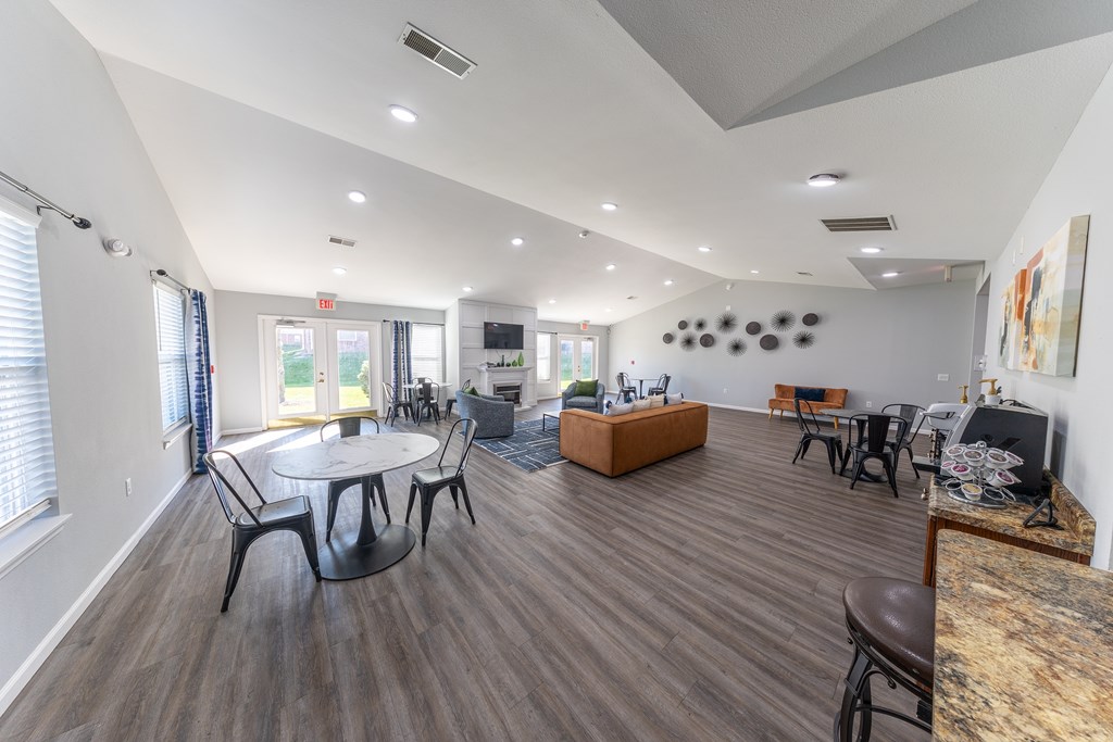 A spacious living room with a dining table and chairs.