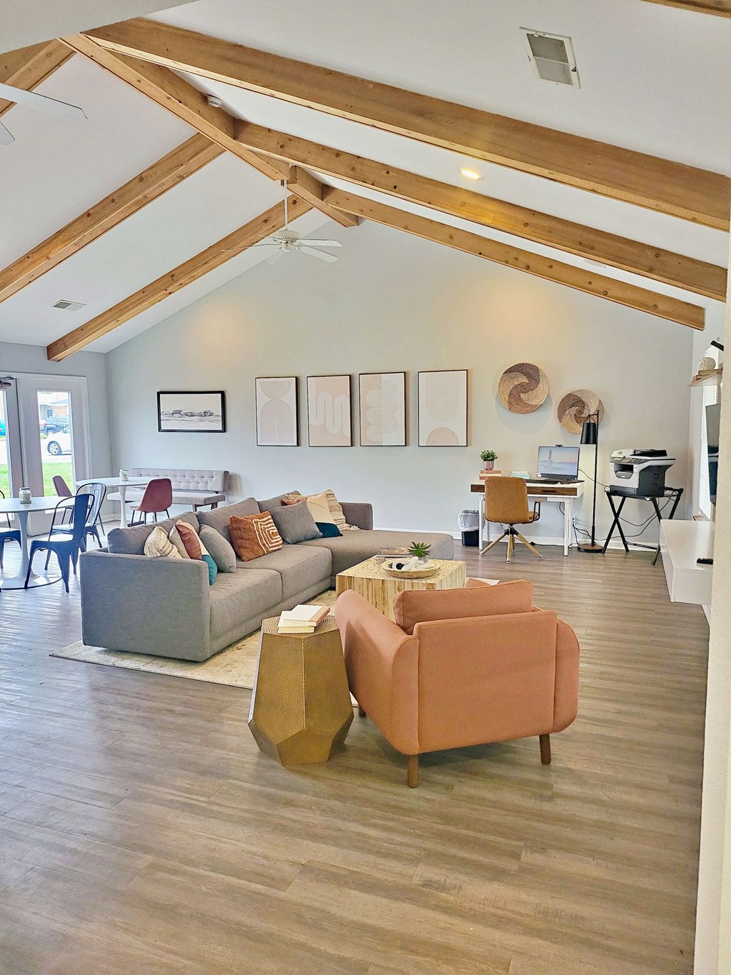 a living room with couches and chairs and a dining room table