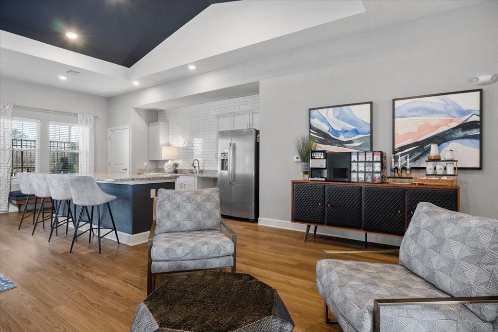 a living room with a kitchen and a table and chairs