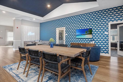 a dining room with a wooden table and chairs