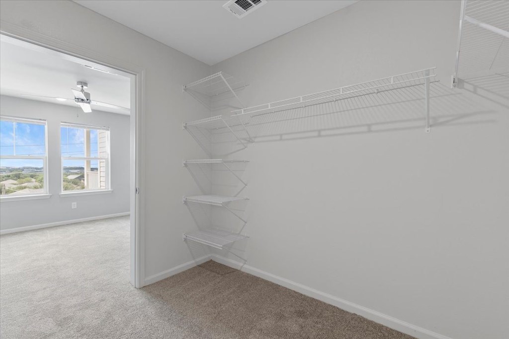 Empty room with white walls and carpeted floor.