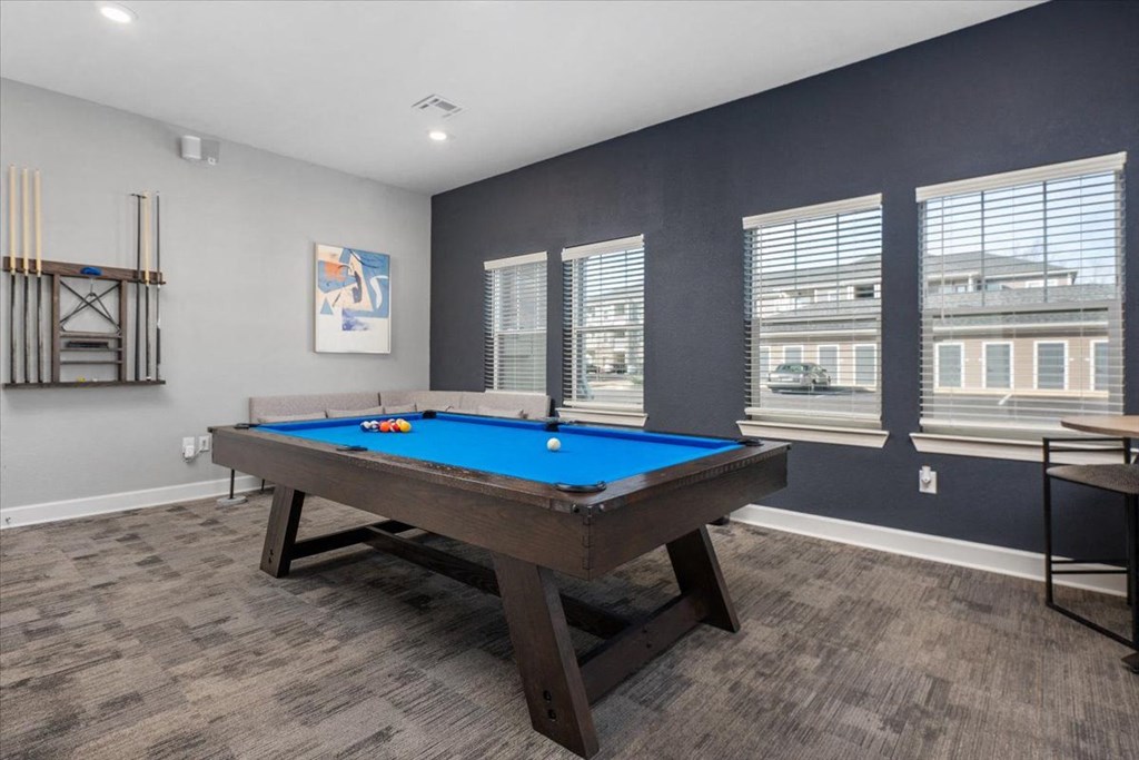 a games room with a pool table