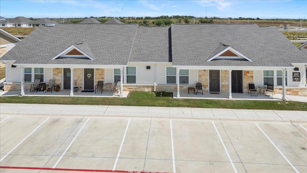 A building with a parking lot in front of it.