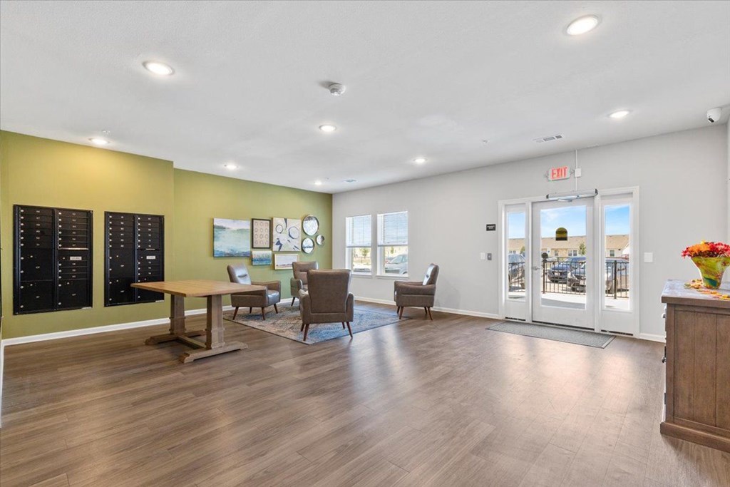 A room with a wooden floor and a table with chairs.