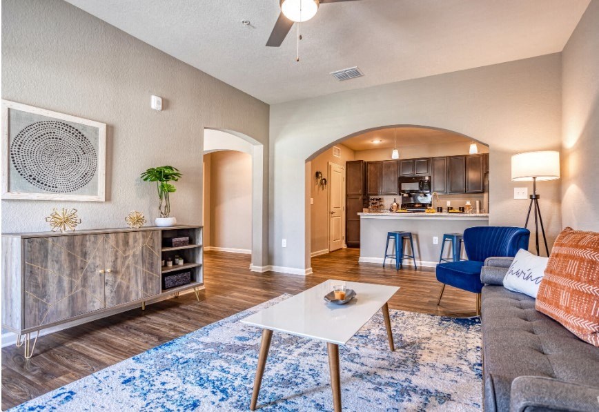 A living room with couch, table, and cabinets at the Flats at Sundown in North Port, Florida
