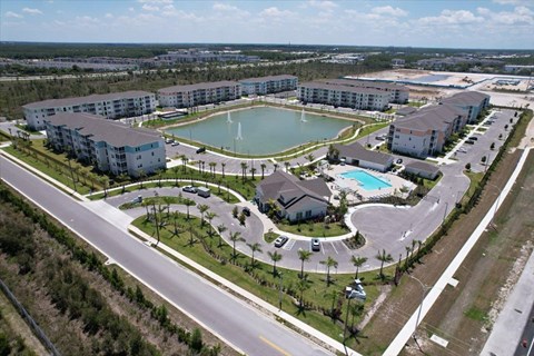 A large resort with a pool and a lake.
