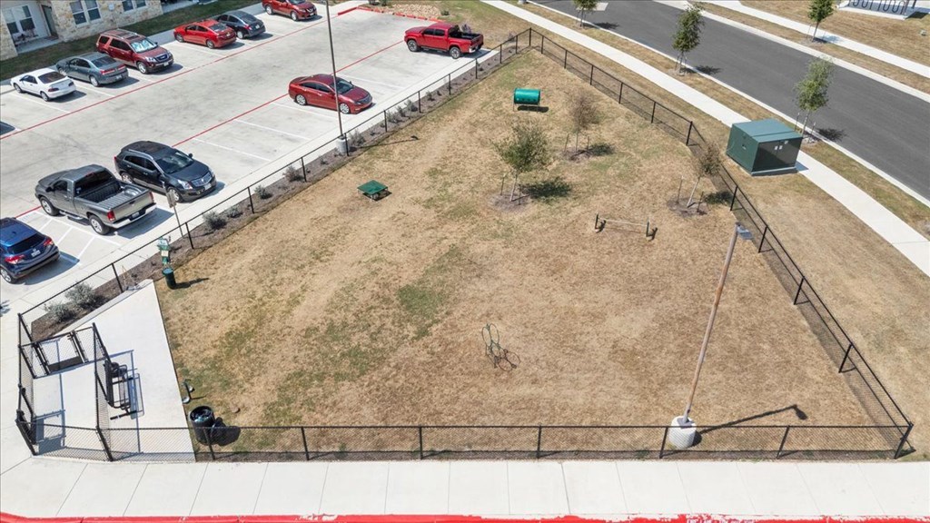 a fenced in dog park at legacy square senior apartments in san marcos
