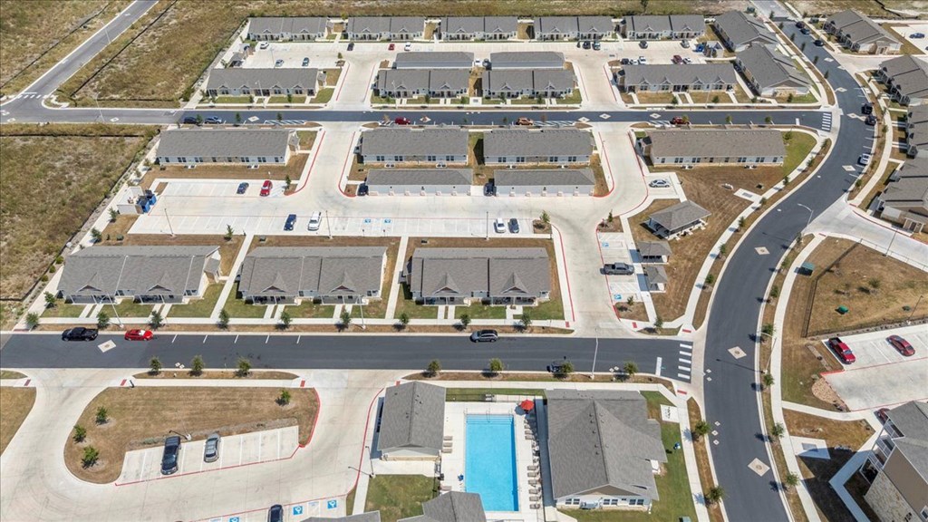 A bird's eye view of legacy square senior apartments and a swimming pool.