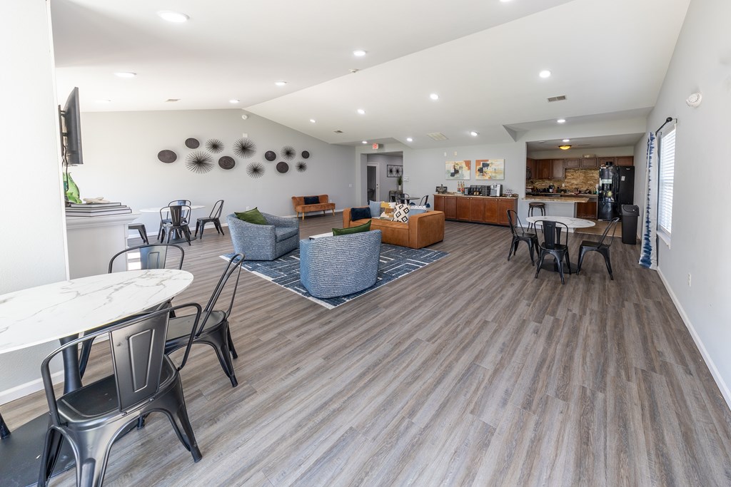 A spacious living room with a dining table and chairs.