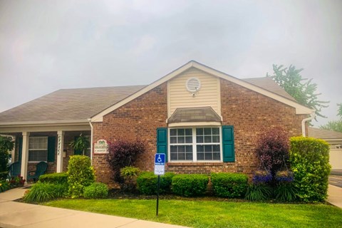 A house with a sign in front of it.