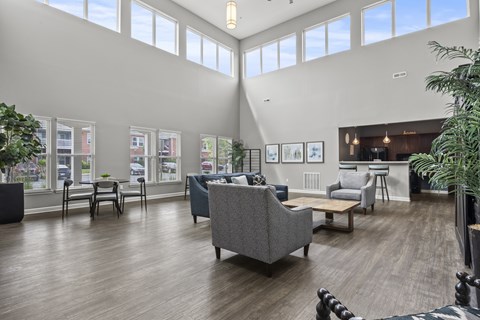 A spacious waiting room with a variety of seating options and pictures on the wall.