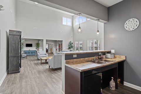 A kitchen with a sink and a countertop with a bag of chips on it.