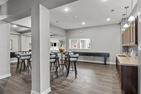 A modern dining room with a long table and chairs.