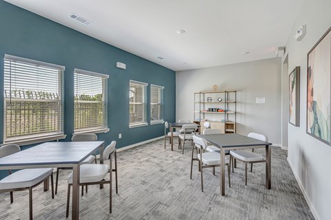 A conference room with a long table and chairs.