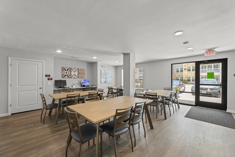 A conference room with a long table and chairs.