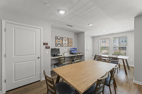 A dining room with a wooden table and chairs.