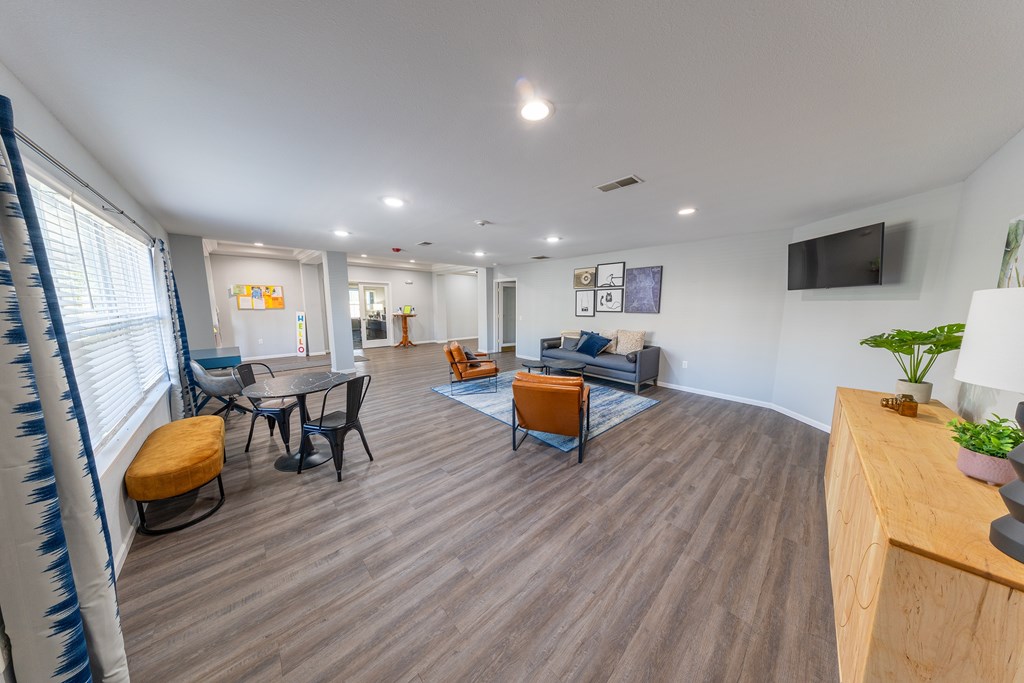 A living room with a wooden floor and furniture.