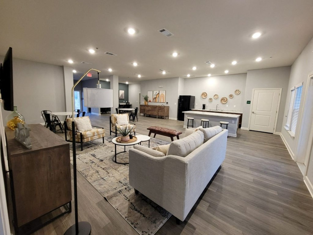 a large living room with a couch and a table at Agave East apartments