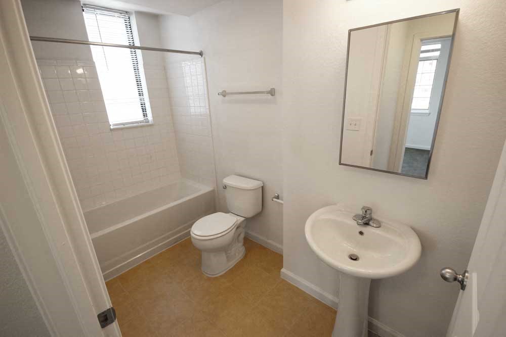 a bathroom with a toilet sink and bathtub