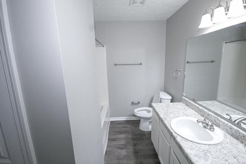 Bathroom with a sink toilet and mirror.