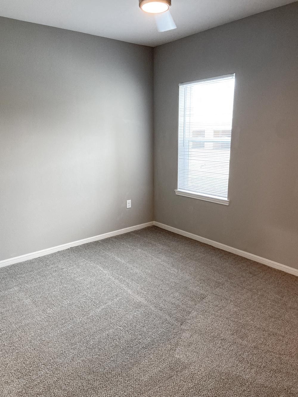 Empty bedroom with carpeting at Promenade Luxury apartments in Beaumont, Texas