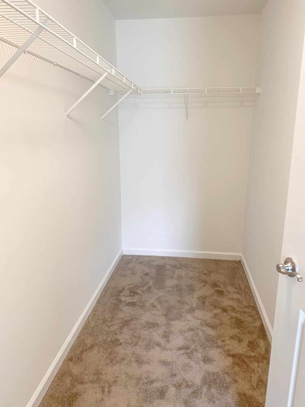 Large closet with white walls and a shelf at Summerset Apartments in Kokomo, Indiana