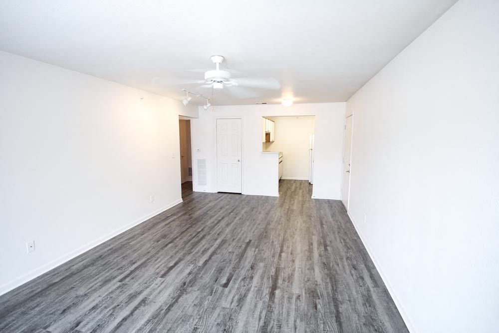 Empty living room with a ceiling fan at Canterbury House Newburgh Apartments in Newburgh, IN
