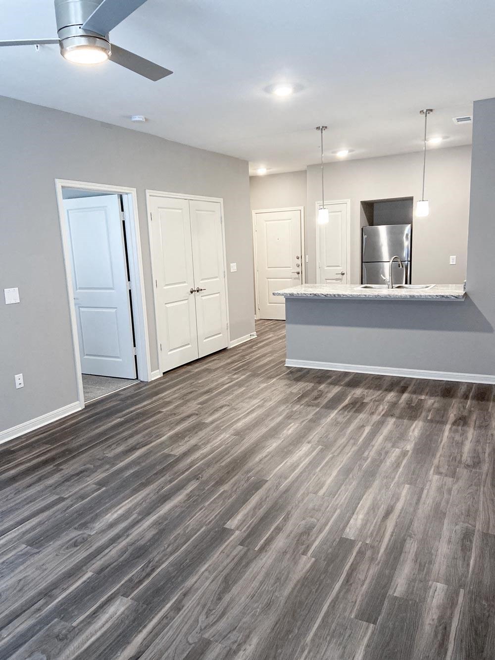Empty living room with wood floor at Promenade Luxury apartments in Beaumont, Texas