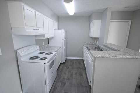 a kitchen with white appliances and white cabinets