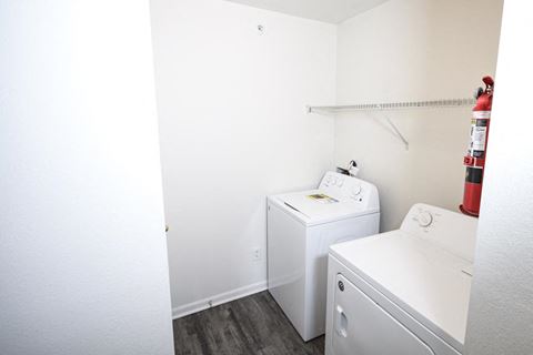 Small laundry room with a washer and dryer at Canterbury House Newburgh Apartments in Newburgh, IN