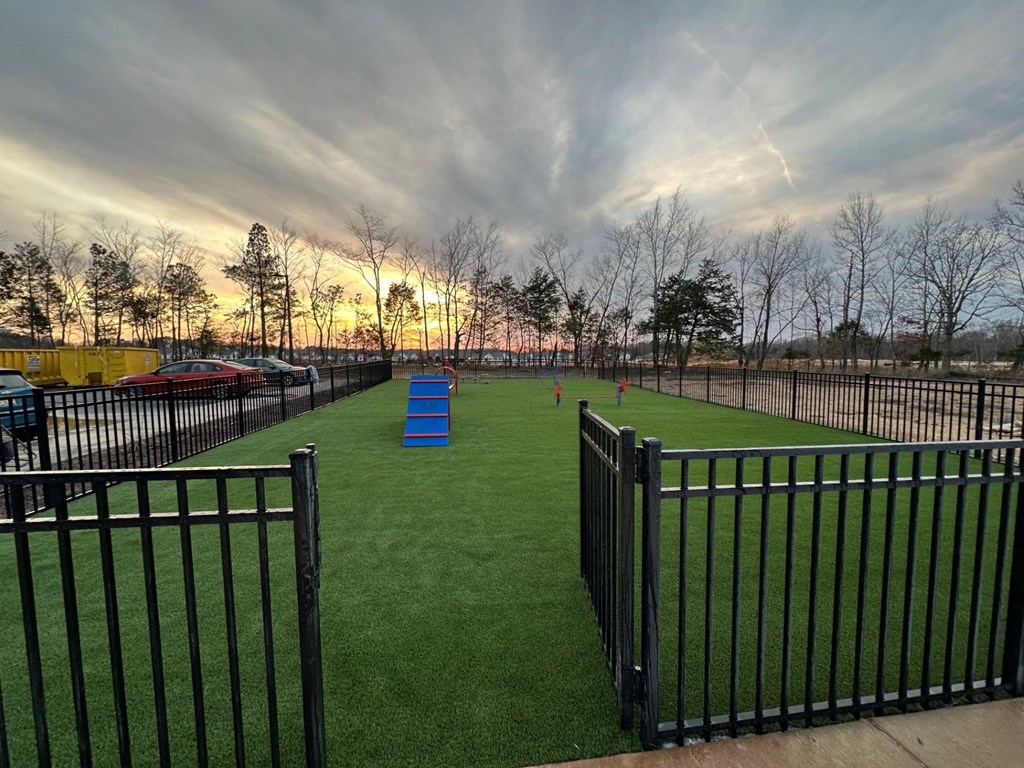 Dog park with a fence at Aurora Apartments