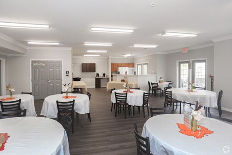 A dining room with tables set for a meal.