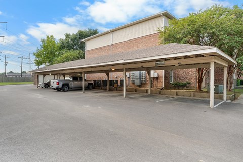 A parking lot with a building in the background.