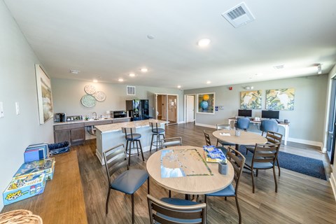 A dining room with a wooden table surrounded by chairs.
