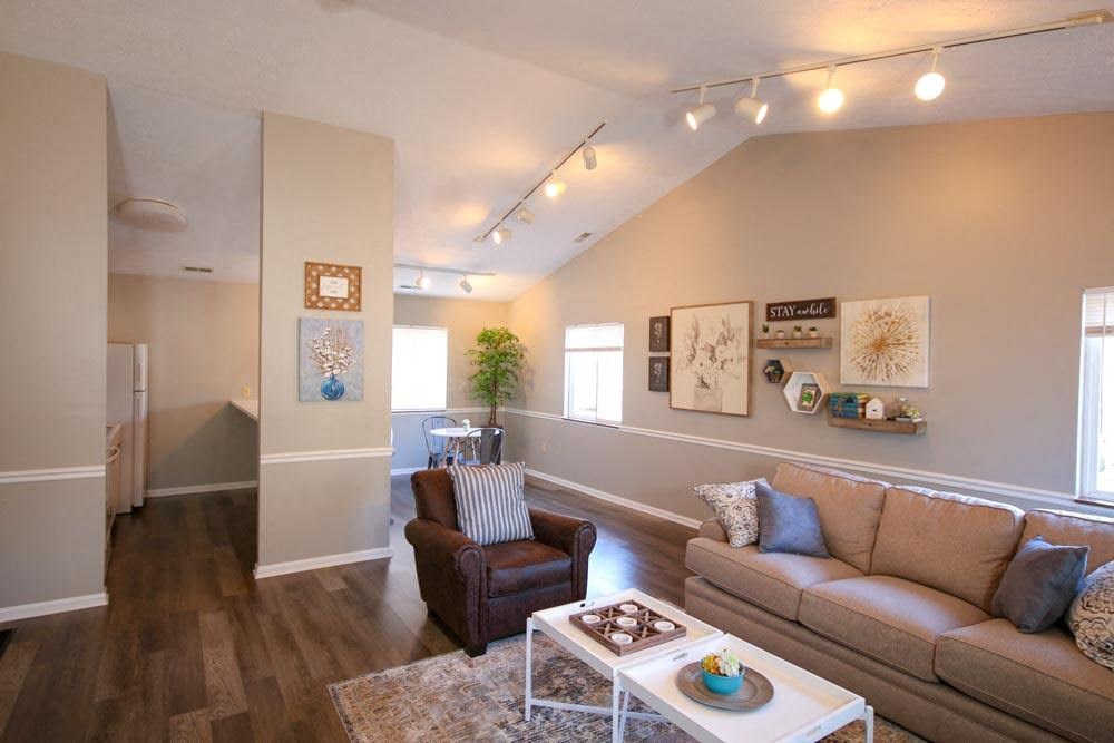 Clubhouse living room with a couch chair and coffee table at Canterbury House apartments in Logansport, Indiana